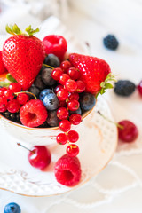 Mix of fresh berries in a cup of tea