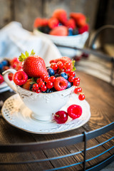 Mix of fresh berries in a cup of tea