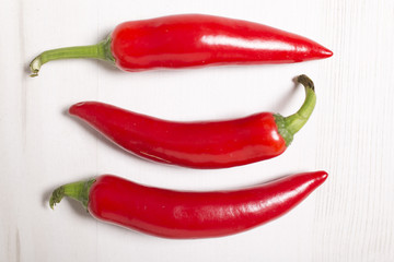 Fresh red chilli on a light wooden kitchen work surface