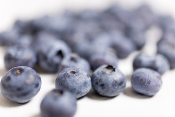 Fresh blueberries on a light wooden kitchen work surface