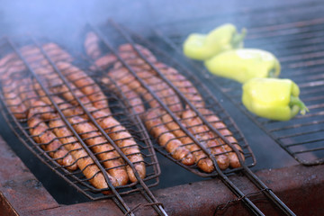 preparing sausages on fire