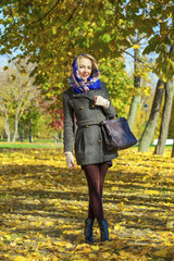 Young woman walking in autumn park