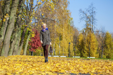 Fototapeta premium Young woman walking in autumn park