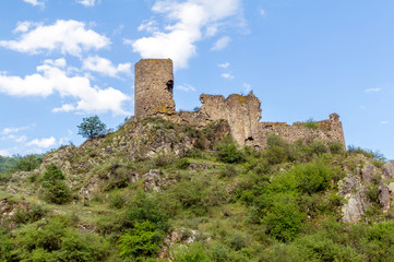 Fototapeta na wymiar Medieval fortress Moktsevis against the blue sky, Georgia