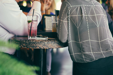 People drinking cocktails at the bar