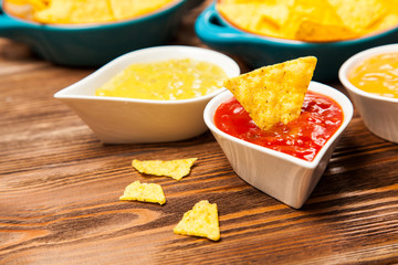 Plate of nachos with different dips