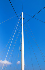 The mast of the ship on a blue sky background