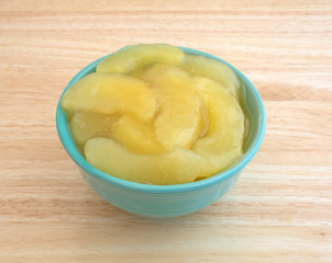 Green bowl filled with canned apple pie filling