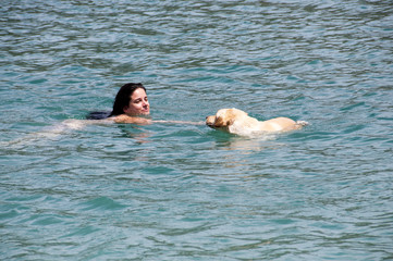 swimming.
girl swimming with your dog