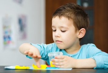 Boy playing with color play dough