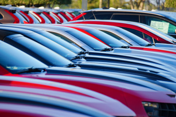 Sunrise at a jam packed parking sales lot with many rows of automobiles