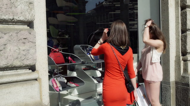 Women doing shopping in the city, steadycam shot
