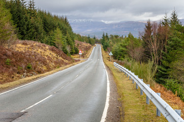 Fototapeta na wymiar Mountain road in Scotland and Cloudy Sky