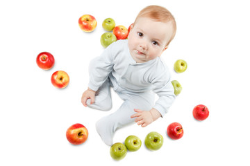 Fototapeta na wymiar Baby plays with apples. Studio Portrait , isolated on a white background