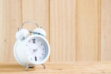 Alarm clock on wood background.