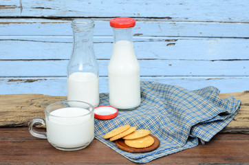 Milk and cookie put on old wood.