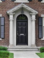 Fototapeta na wymiar black front door with gable style portico