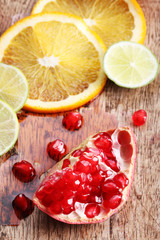red juicy pomegranate with citrus fruits