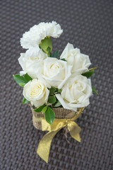 White roses in vase.