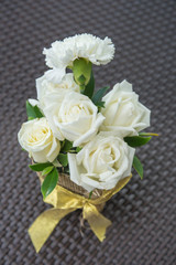 White roses in vase.