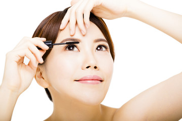 young beautiful woman Applying mascara isolated on white