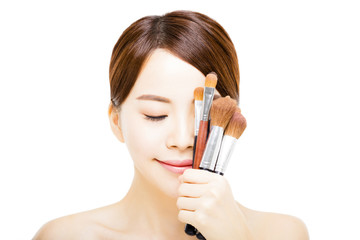 Fototapeta premium young beautiful woman with Makeup Brush