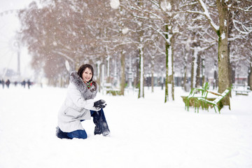 Fototapeta na wymiar Girl enjoying rare snowy winter day in Paris