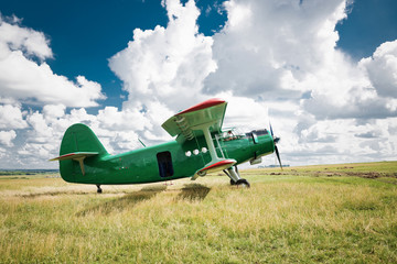 old airplane on green grass