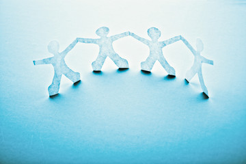 Paper people in teamworking concept