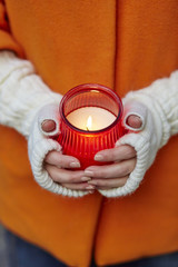 Woman holding burning candle