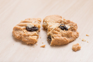 Oatmeal and raisin cookies on wood background.