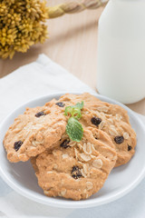 Oatmeal and raisin cookies with milk.