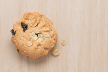 Oatmeal and raisin cookie on wood background. Top view.