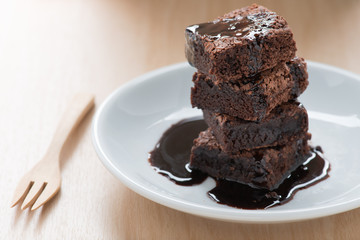 Chocolate brownies on white plate.