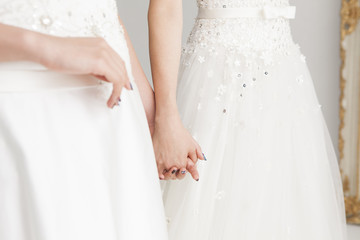Two people of the bride holding hands