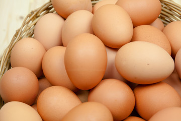 Full of Eggs put in a wicker basket in wooden background