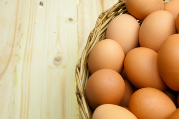 Full of Eggs put in a wicker basket in wooden background