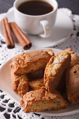cantuccini with almonds and coffee with cinnamon close-up. vertical
