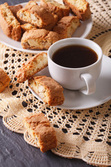 Black coffee and cookies with almonds on a table close-up. vertical
