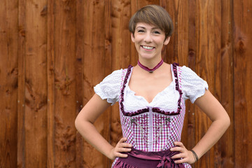 Fototapeta premium Smiling confident German lady wearing a dirndl