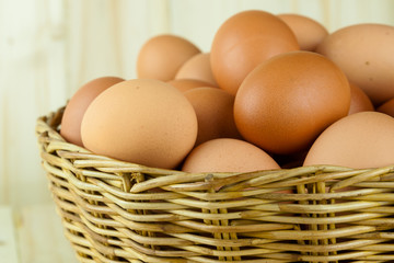 Full of Eggs put in a wicker basket in wooden background