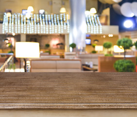 Wooden presentation table and blurred cafe background