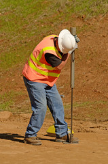 Engineer using a Nuclear Density Gauge to check for soil density of a soil lift 