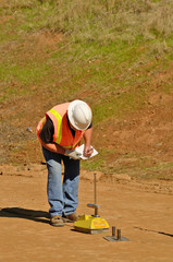 Engineer using a Nuclear Density Gauge to check for soil density of a soil lift 