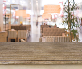 Defocused cafe interior background with wooden table in front