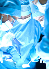 Fototapeta premium Woman dentist working at her patient teeth