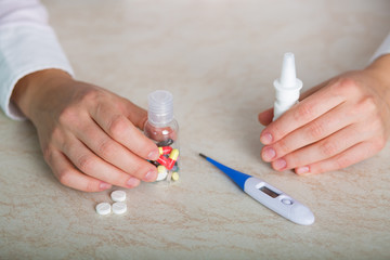 Pretty woman with a bottle of pills