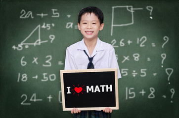 Asian schoolboy in uniform holding chalkboard with text "I Love