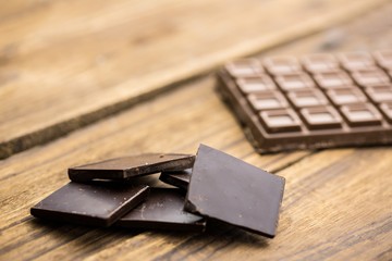Pieces of chocolate on a wooden table
