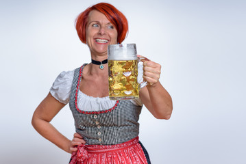 Happy Woman with Mug of Beer Looking Into Distance